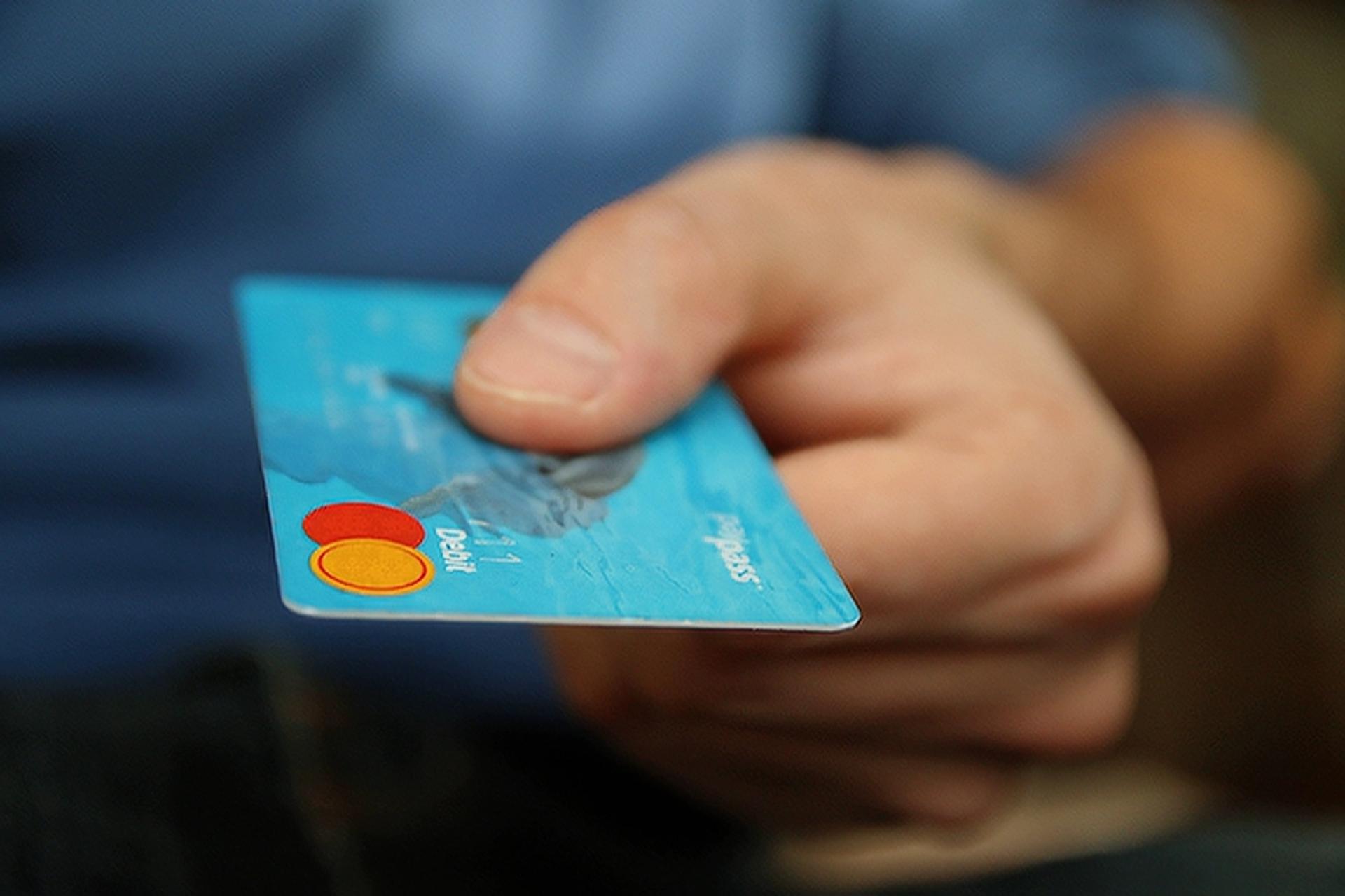 Image of a man handing over a credit card