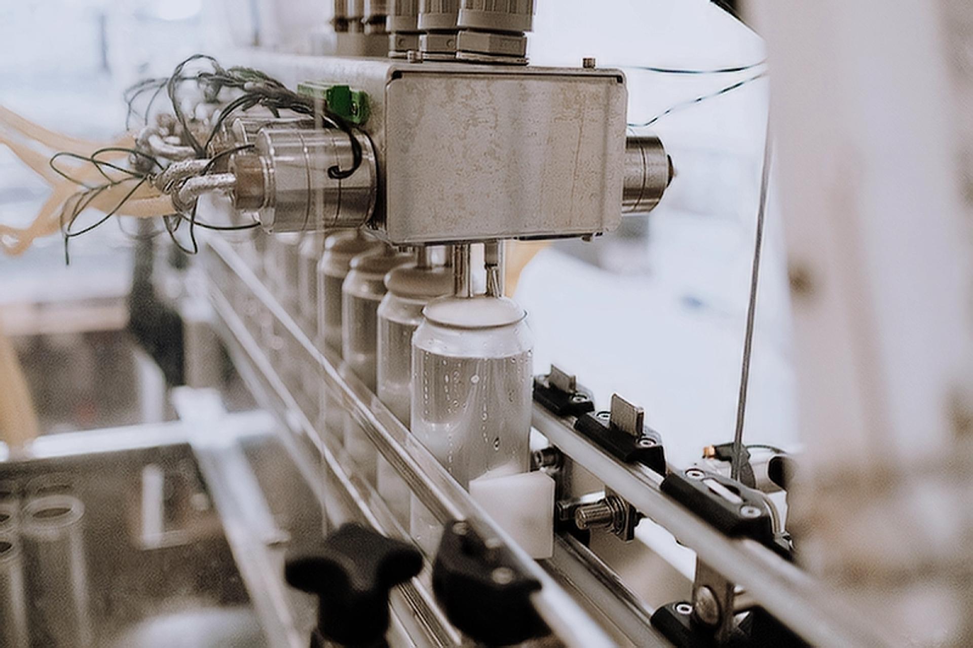 An image of an assembly line making aluminum cans.