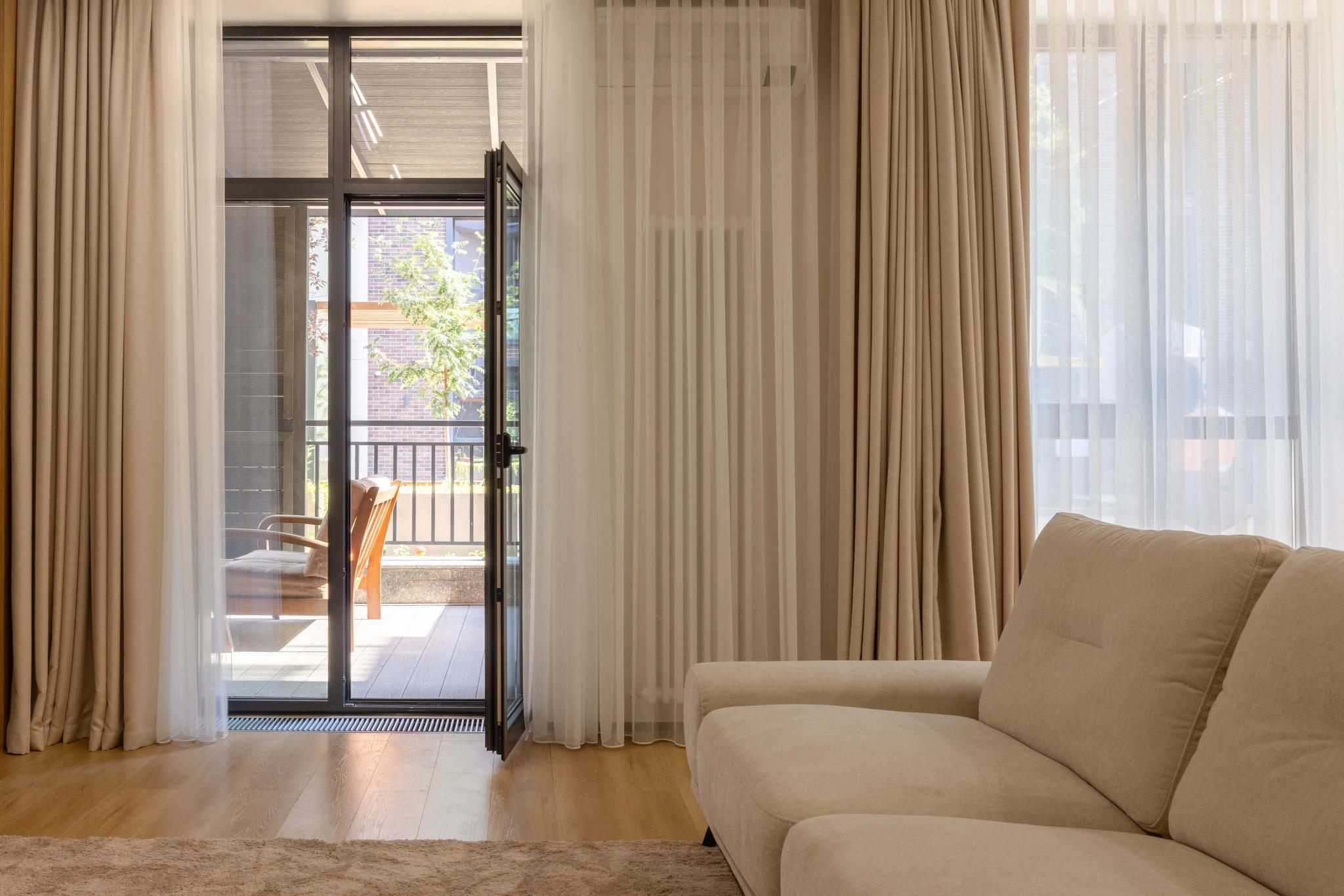 Modern living room with floor-to-ceiling windows and balcony access, luxury interior photography Kazakhstan