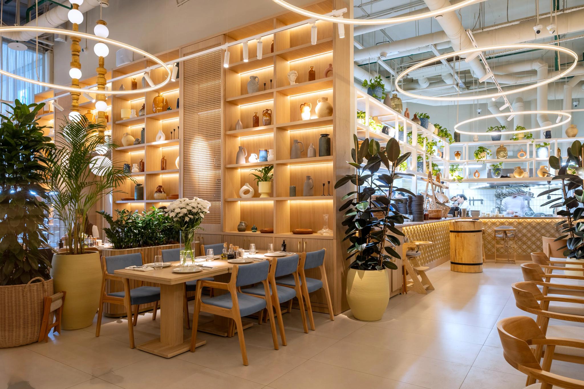 Modern restaurant interior of Syrovarnya in Astana with wooden shelving, indoor plants and dining area - luxury interior photography Kazakhstan