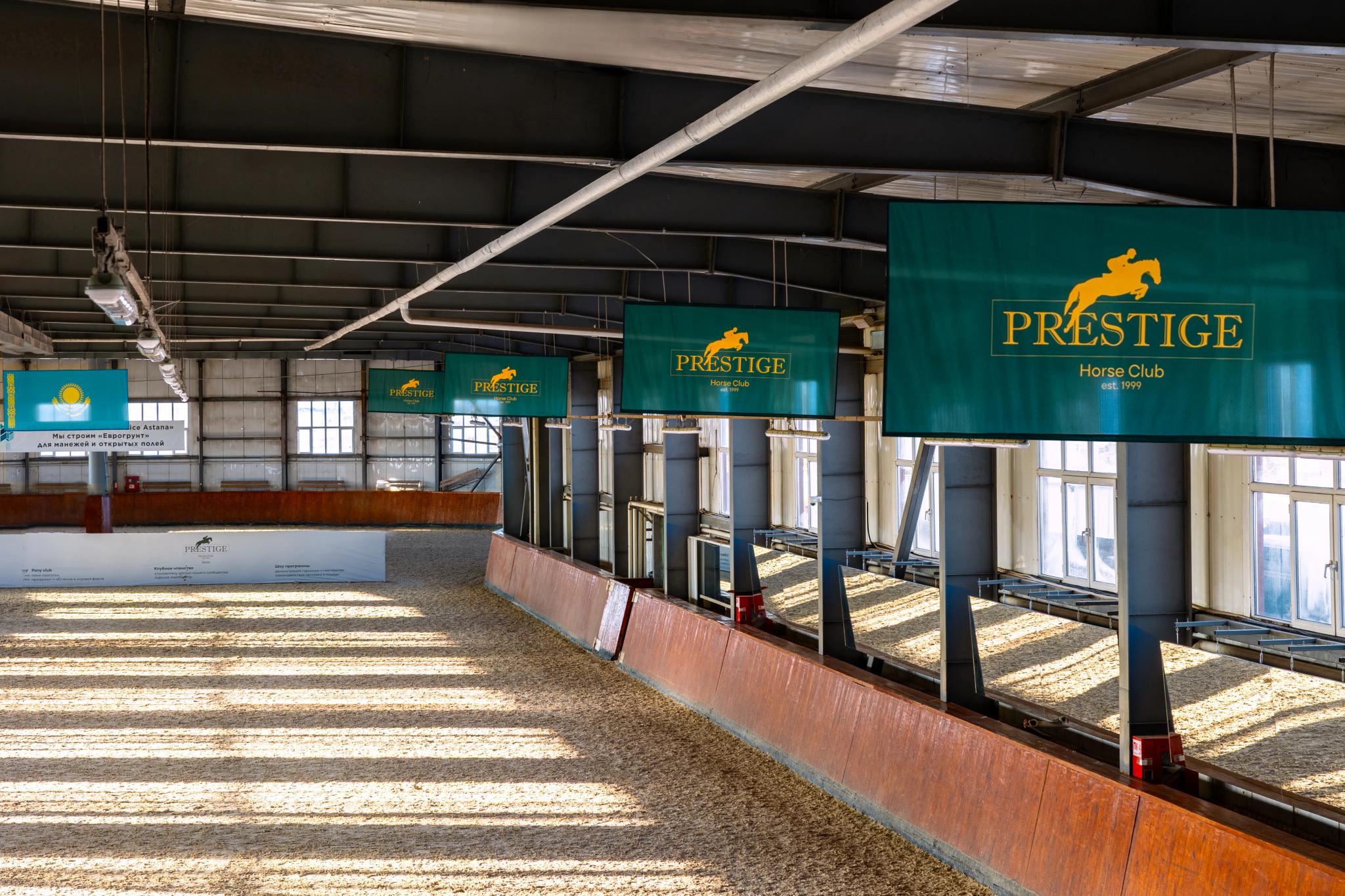 Interior of Prestige equestrian club in Astana featuring architectural photography of modern stables and professional facility design