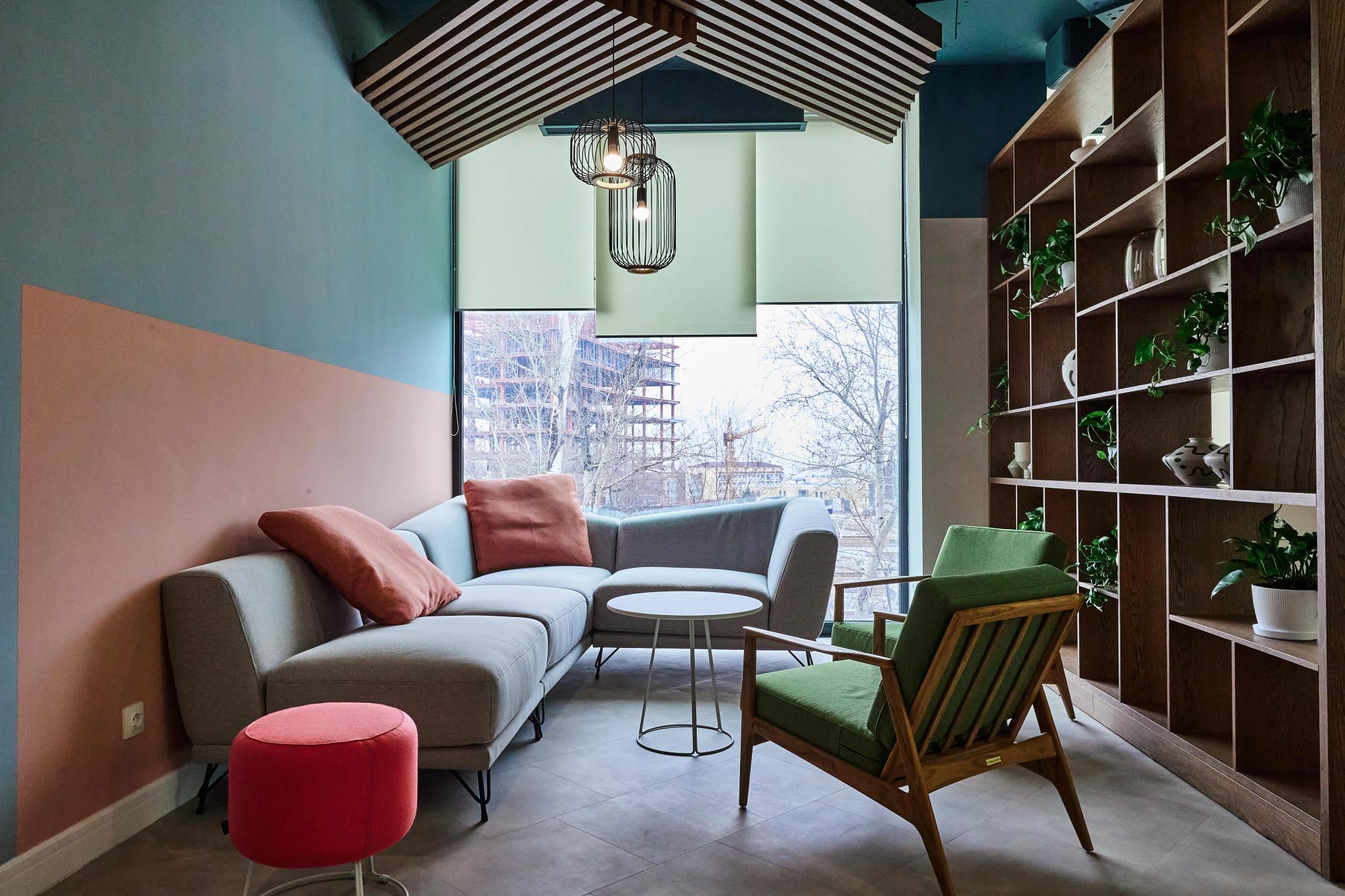 Interior photography of Esentai City open-space office in Almaty: modern commercial interior with modular sofa and wooden shelving