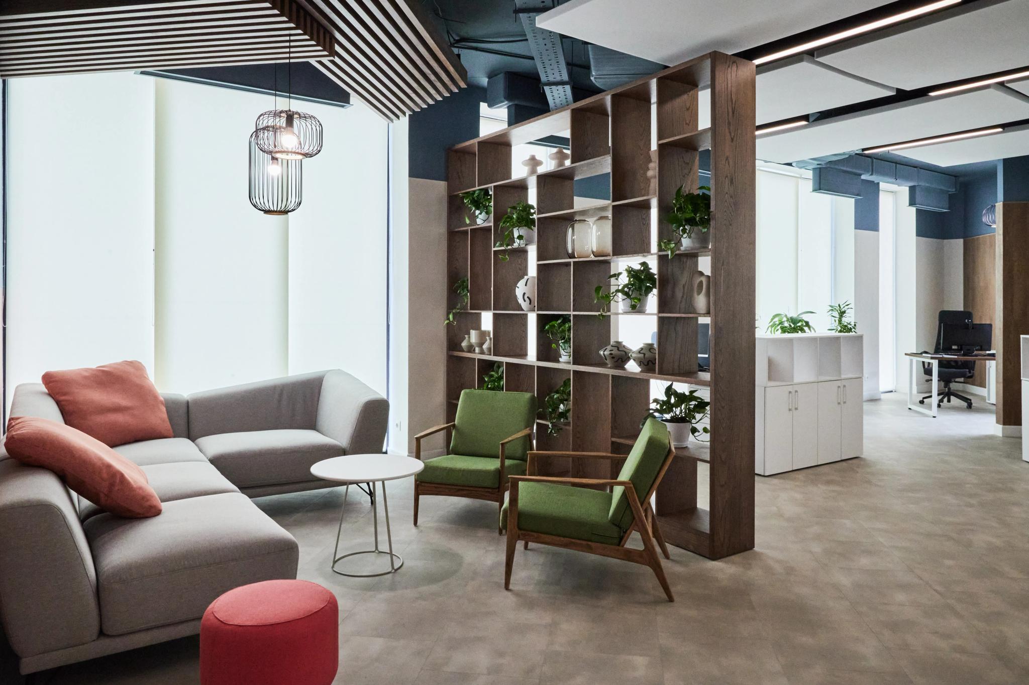 Contemporary open-space office at Esentai City featuring modular seating, wooden shelving units and greenery - professional interior photography Kazakhstan