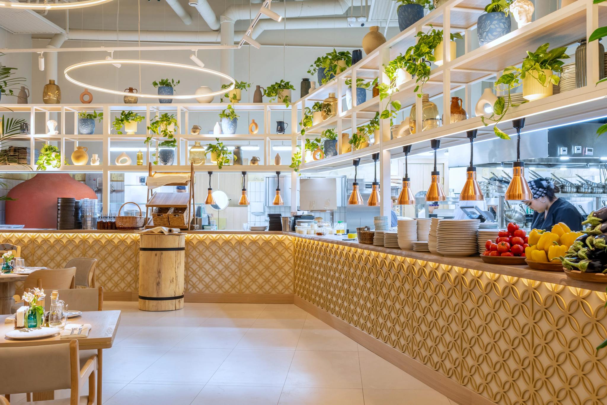 Modern cheese restaurant interior in Astana with wooden counter, pendant lights and plants on shelving - hotel interior photography Kazakhstan