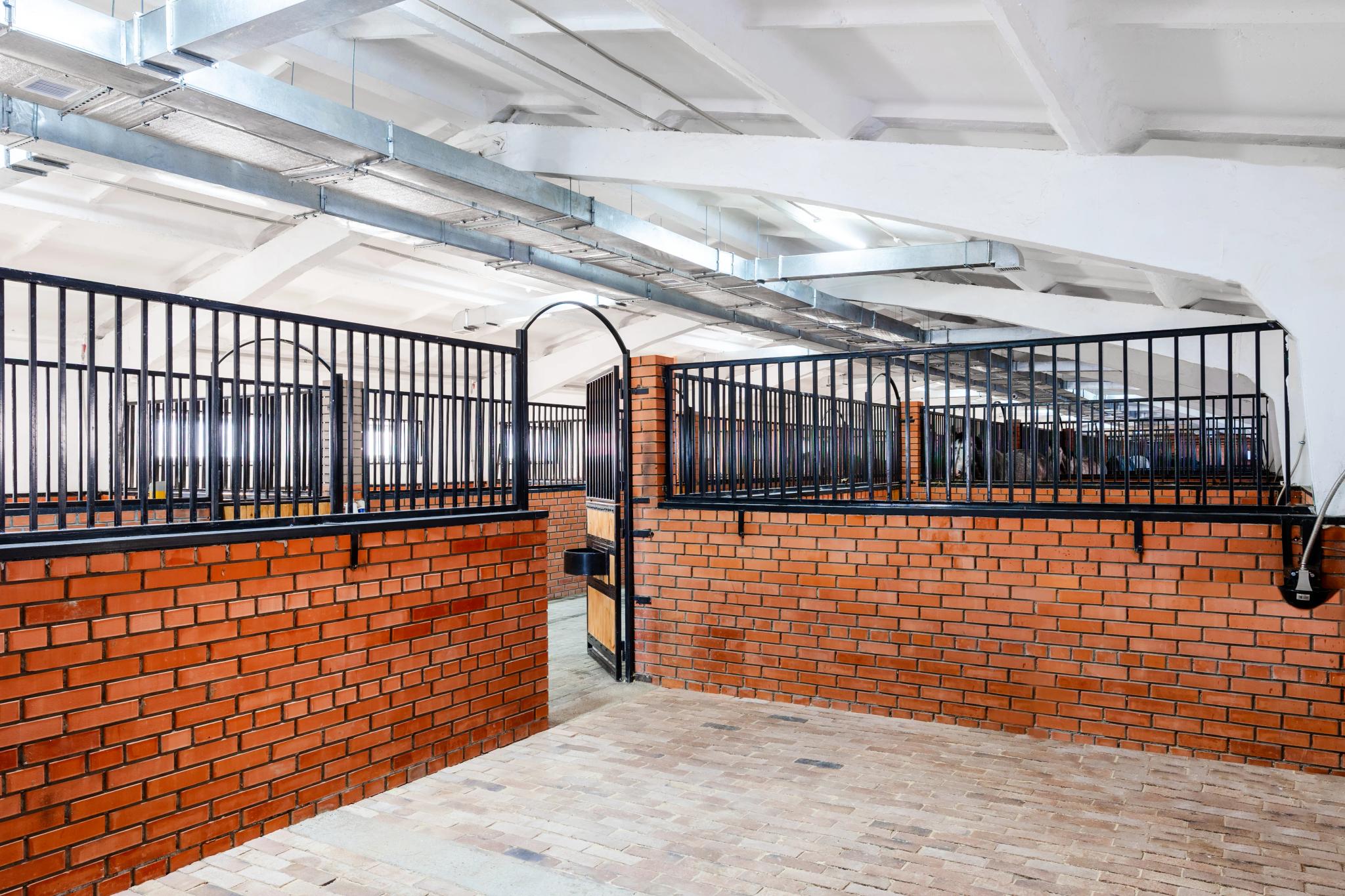 Modern interior of Prestige equestrian club in Astana with brick walls and metal railings, architectural photography Kazakhstan