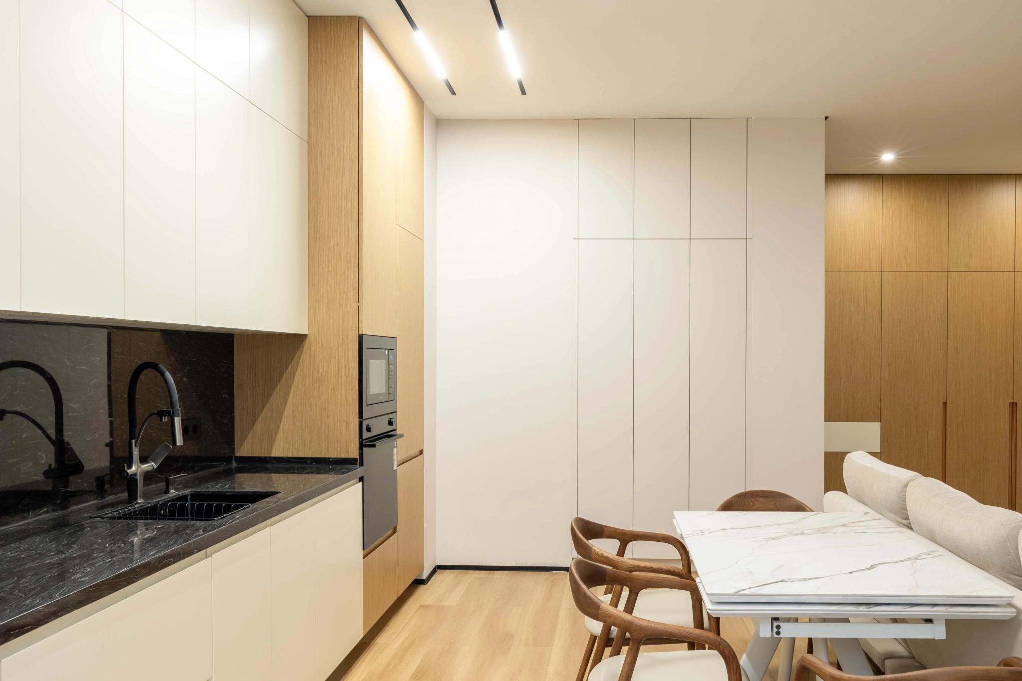 Contemporary studio apartment with kitchen and sleeping area, professional interior photography Kazakhstan