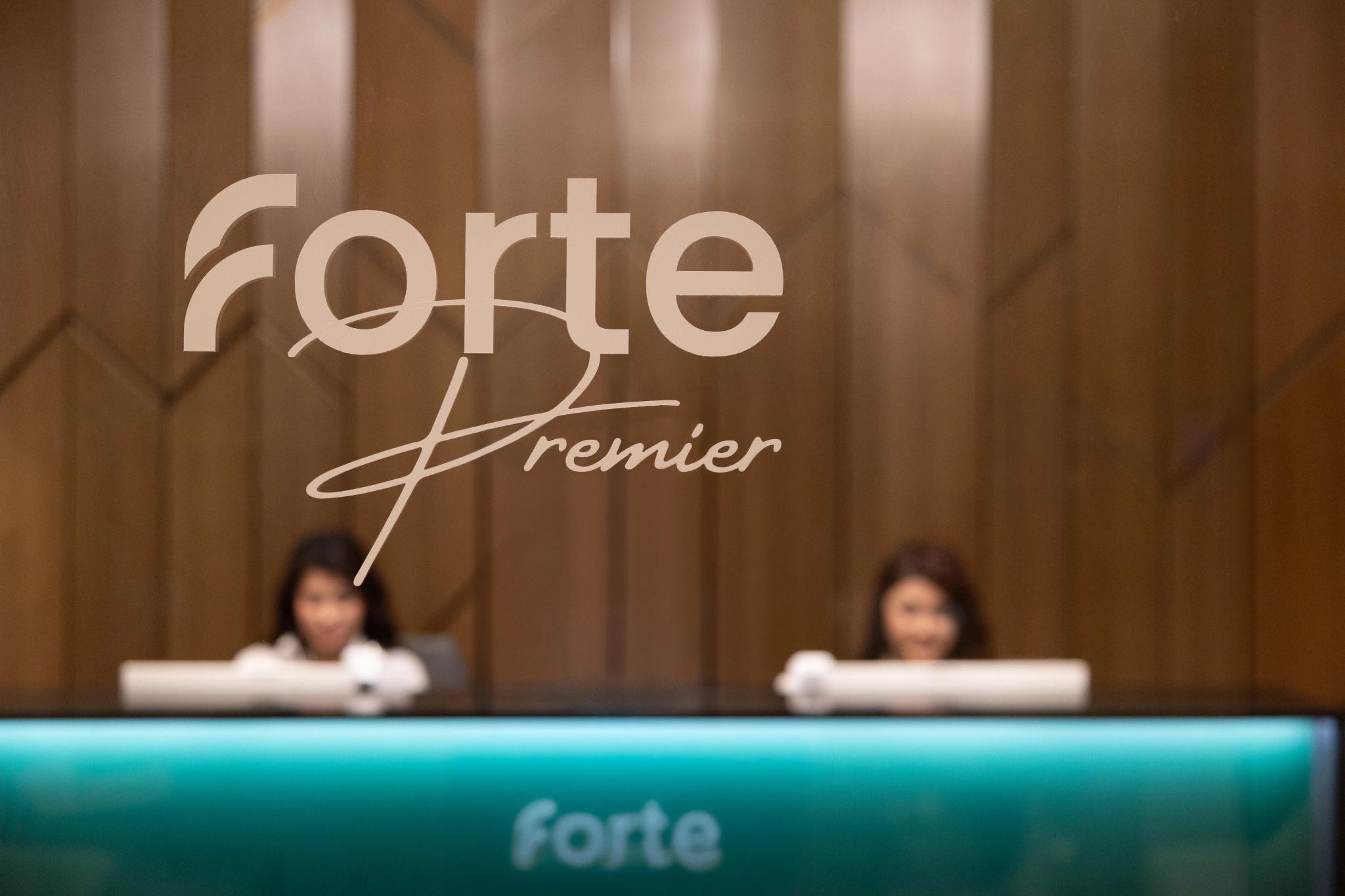 Forte Premier reception desk with logo, professional interior photography of banking office in Astana