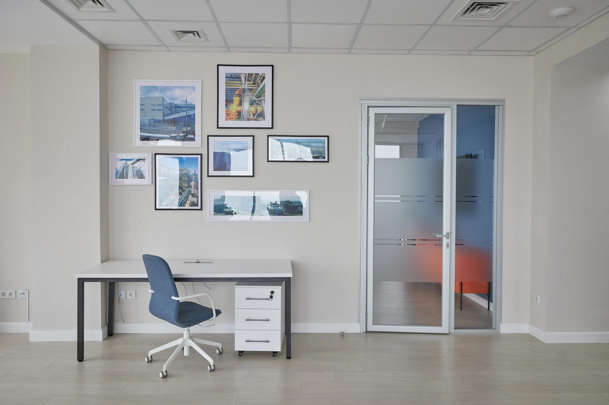 Modern office interior with workspace and photo gallery wall - professional interior photography Kazakhstan by MOSS Bureau