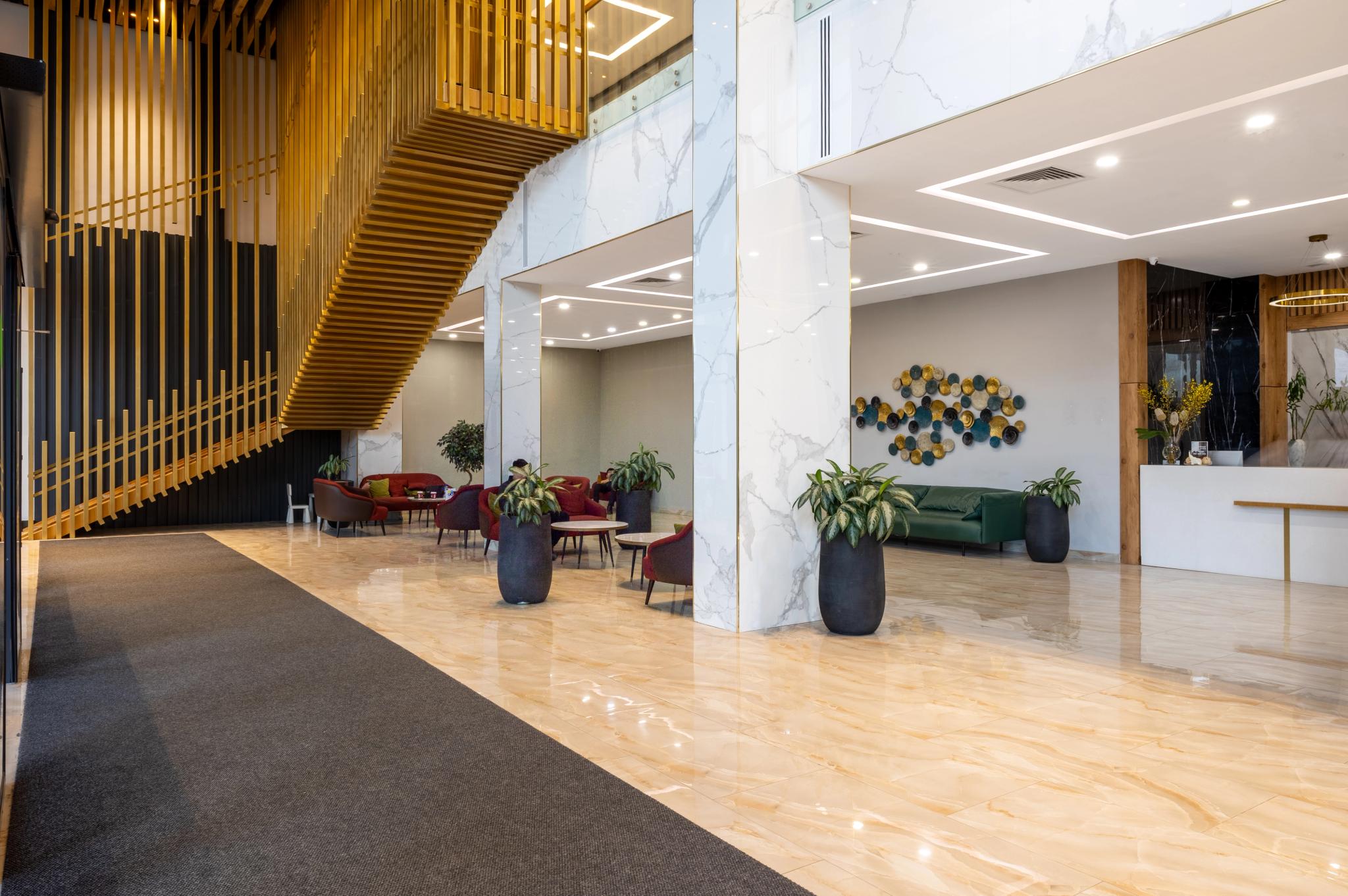 Luxury hotel lobby interior photography of Tor'Re Astana featuring marble columns, golden staircase and designer furniture - commercial interior shoot Kazakhstan