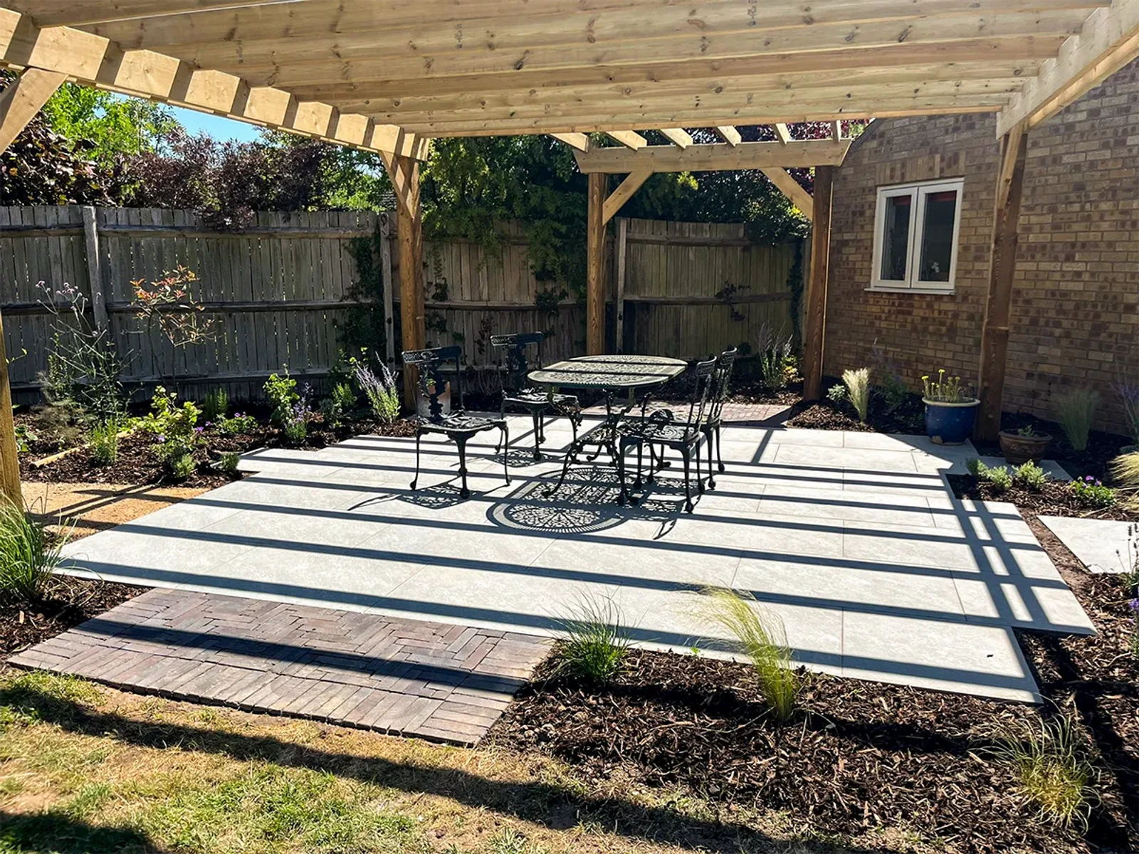 Patio complete, garden furniture in place, finished pergola