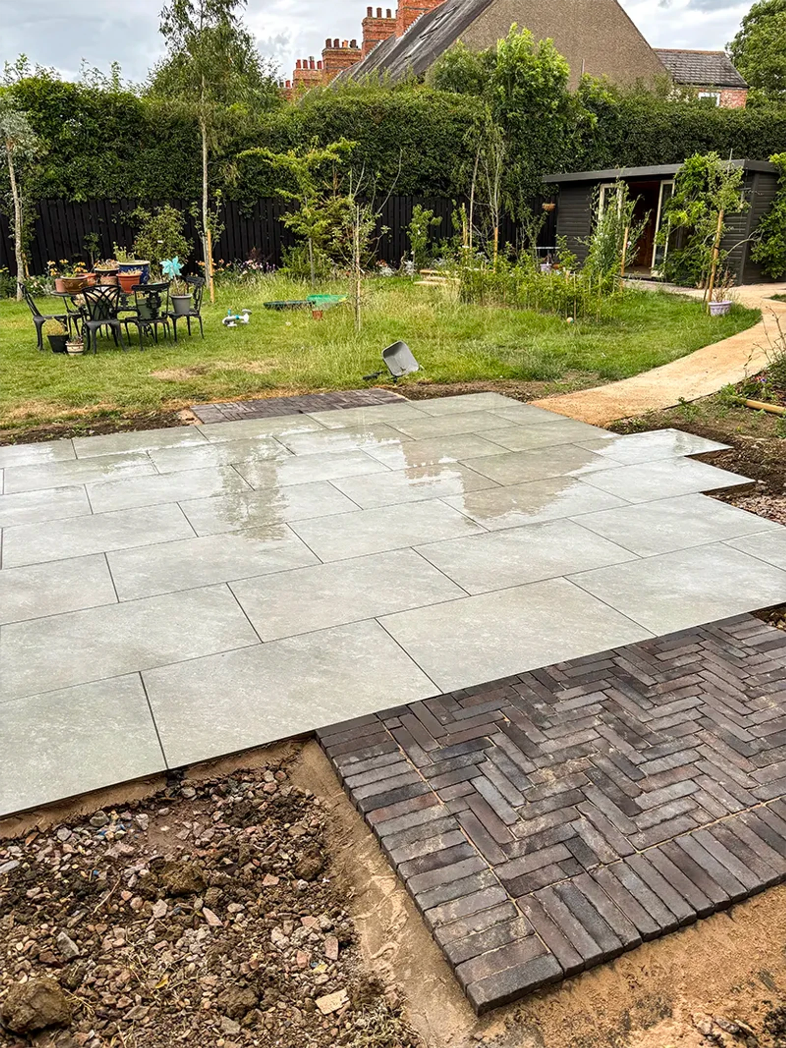 Patio laid, lawned garden in the background