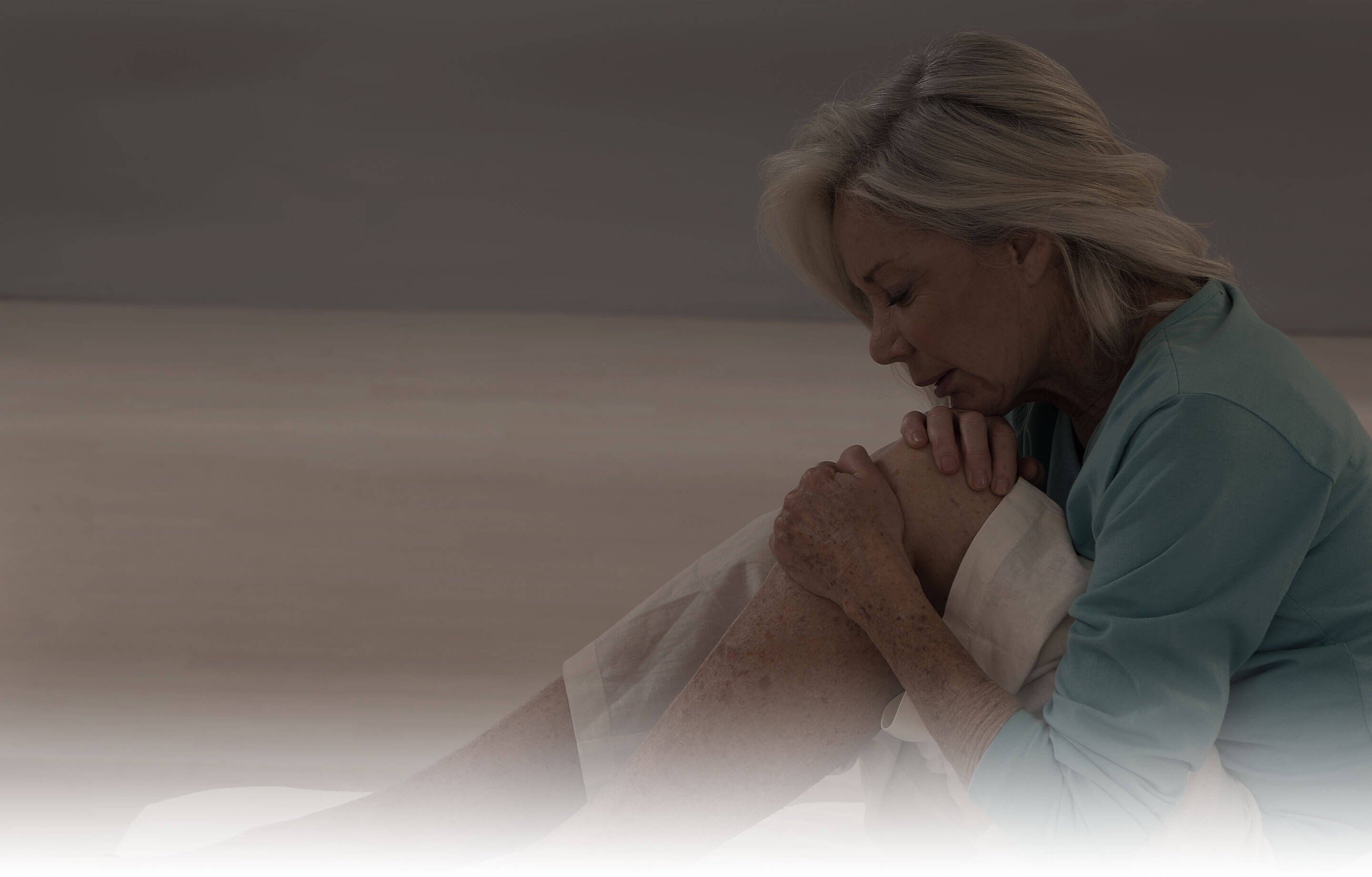 Woman holding her knee with her hands. Woman holding her knee with her hands.