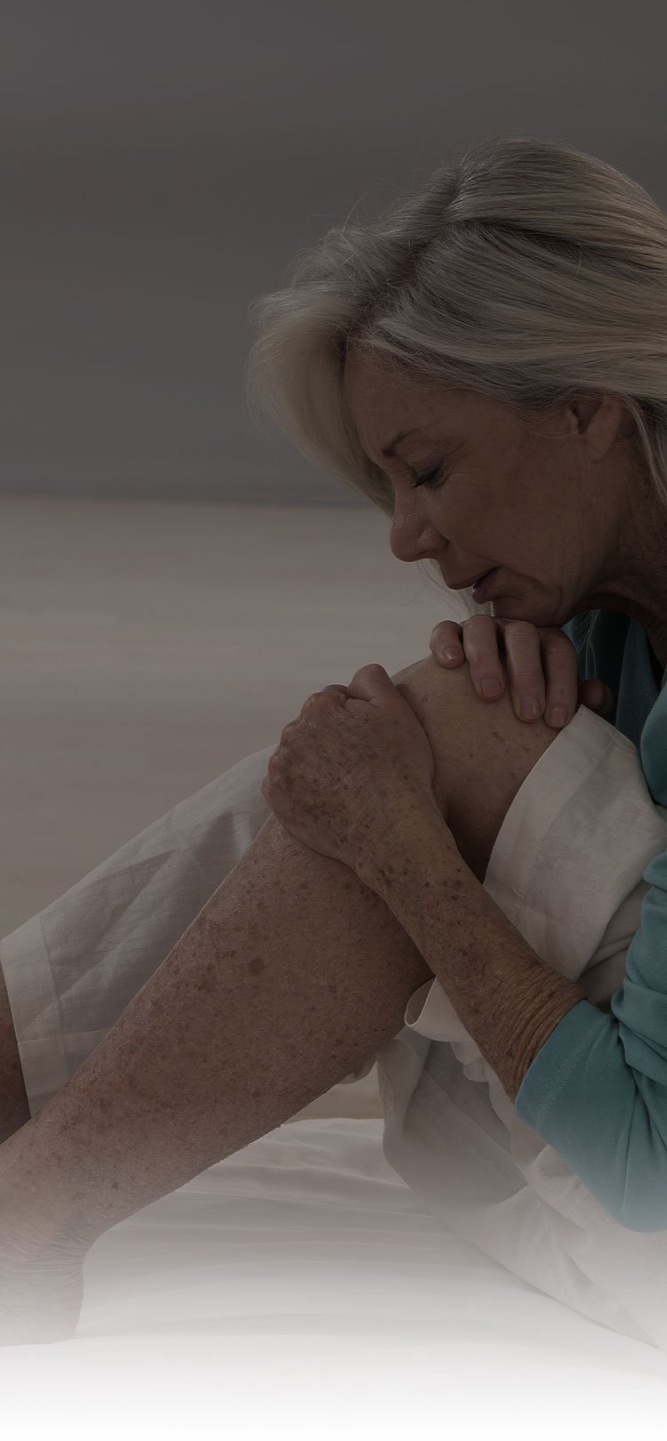 Woman holding her knee with her hands. Woman holding her knee with her hands.