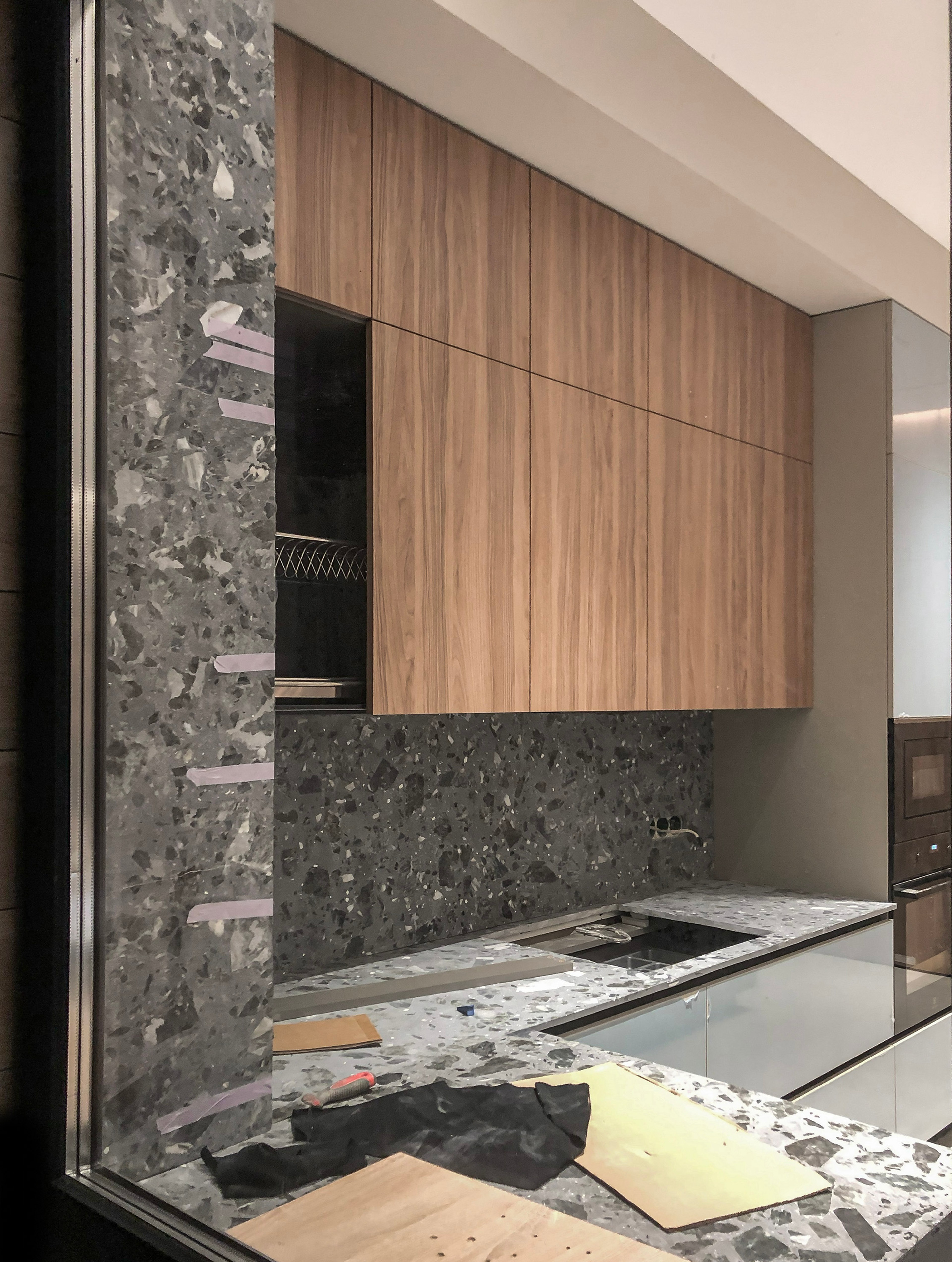Custom large-format stone slabs installed in the kitchen interior of a private residence during construction.