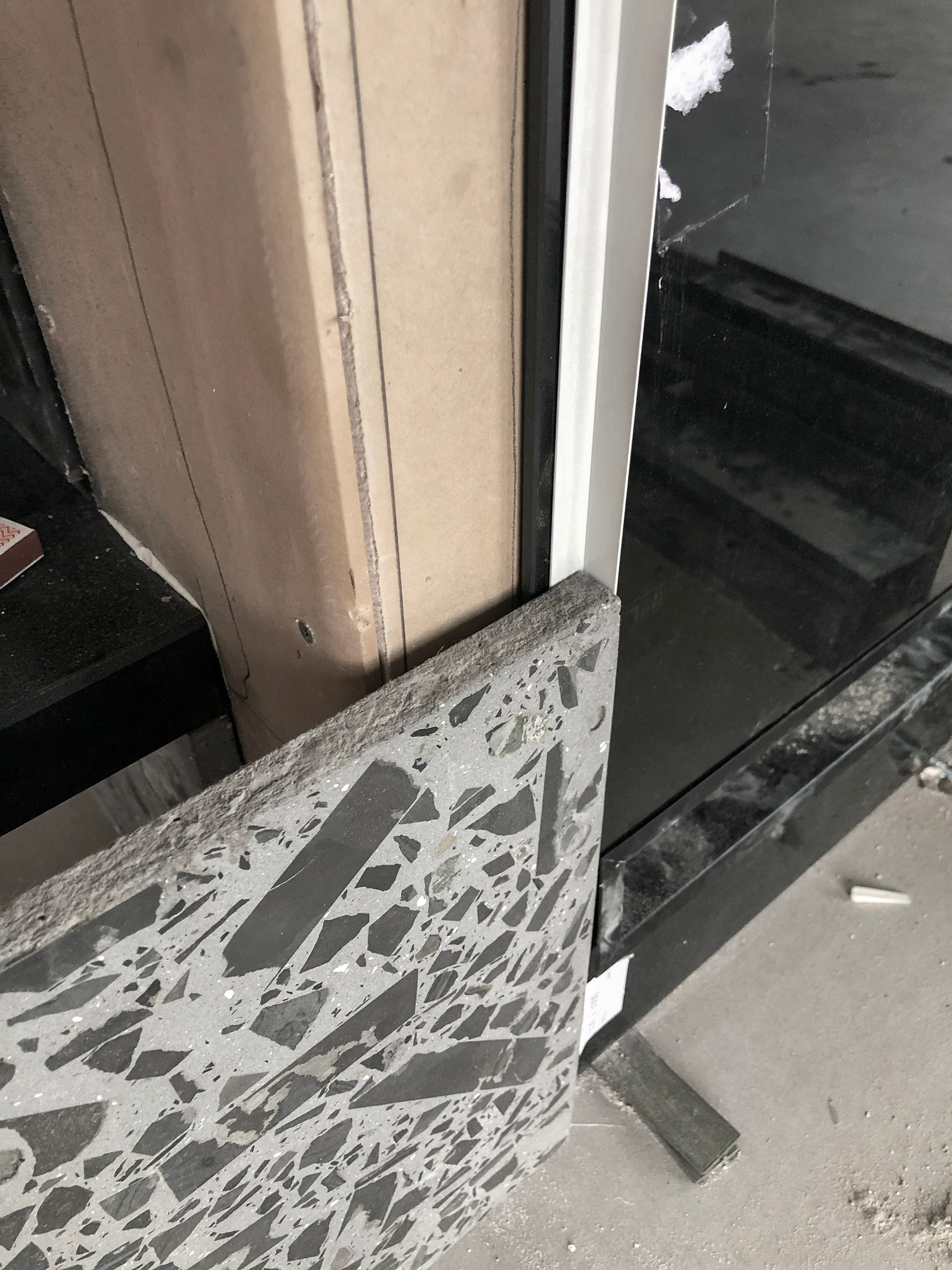 Custom terrazzo stone slab detail showing natural stone aggregate and large-format fabrication for a bespoke interior design project.