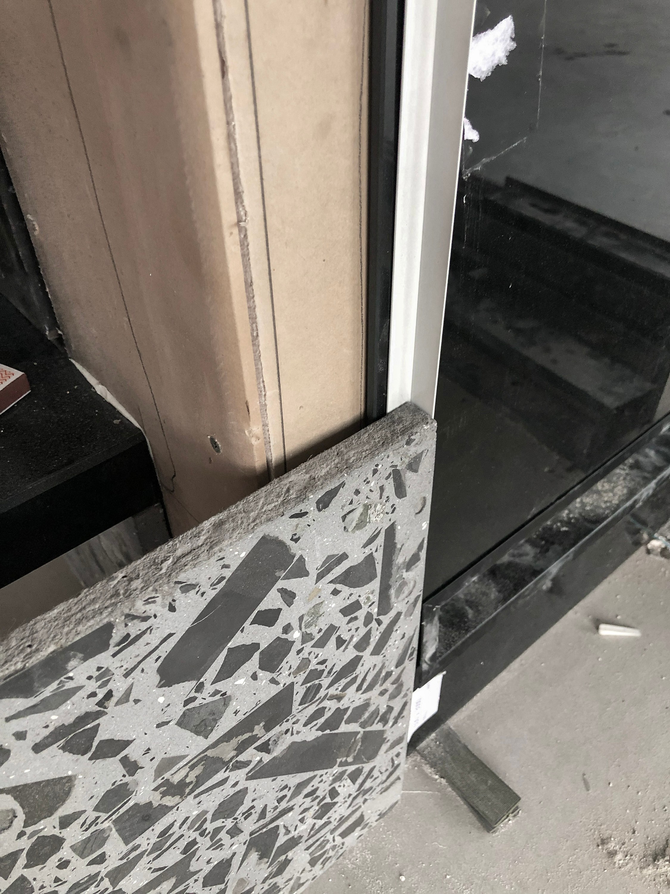 Custom terrazzo stone slab detail showing natural stone aggregate and large-format fabrication for a bespoke interior design project.