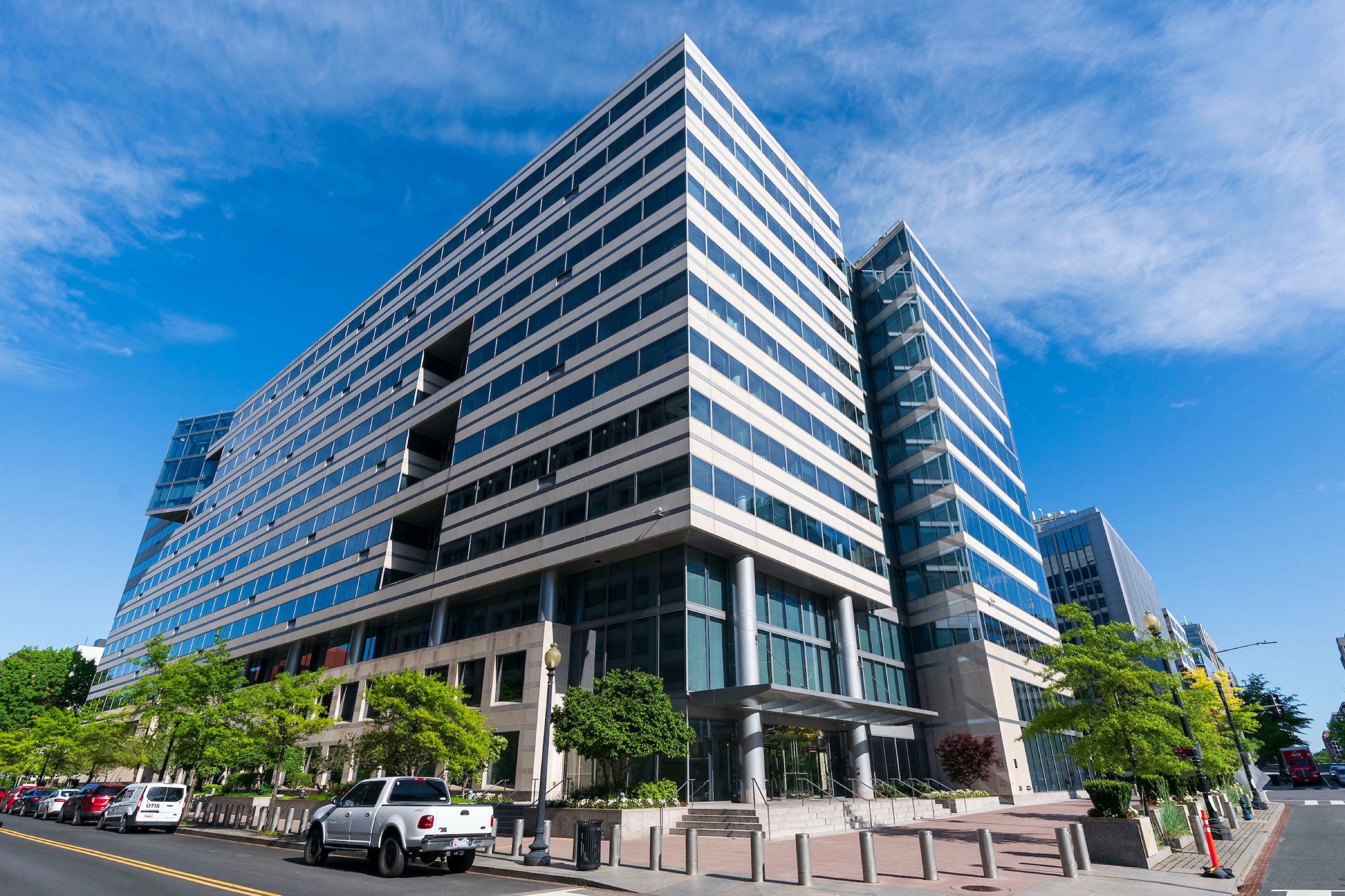 A multistory building displayed with a glass windows and sharp perspective