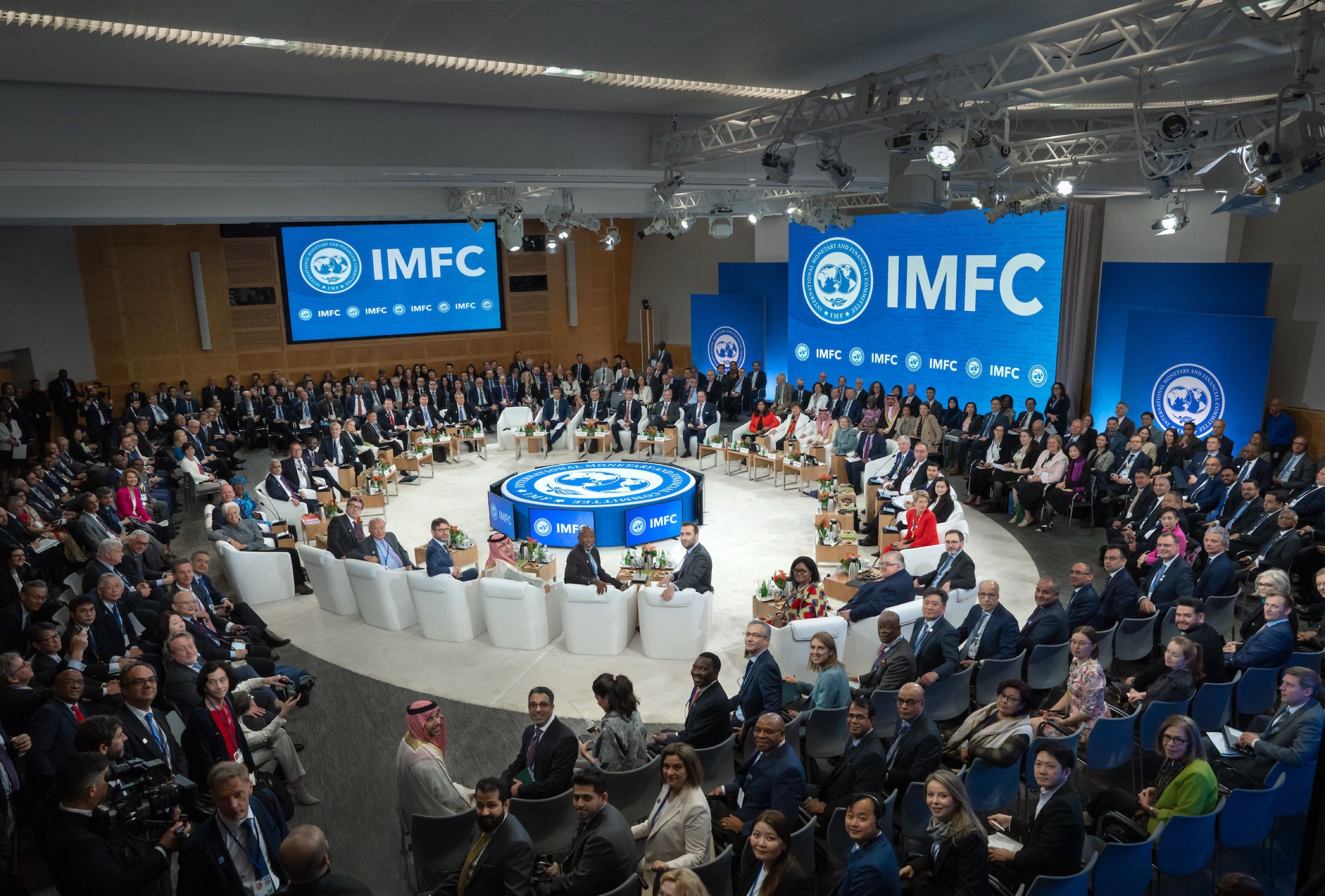 A large group of people gathered at IMFC are seated and turned around to look at the camera