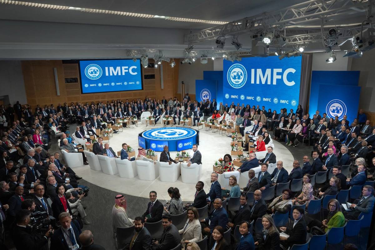 A large group of people gathered at IMFC are seated and turned around to look at the camera