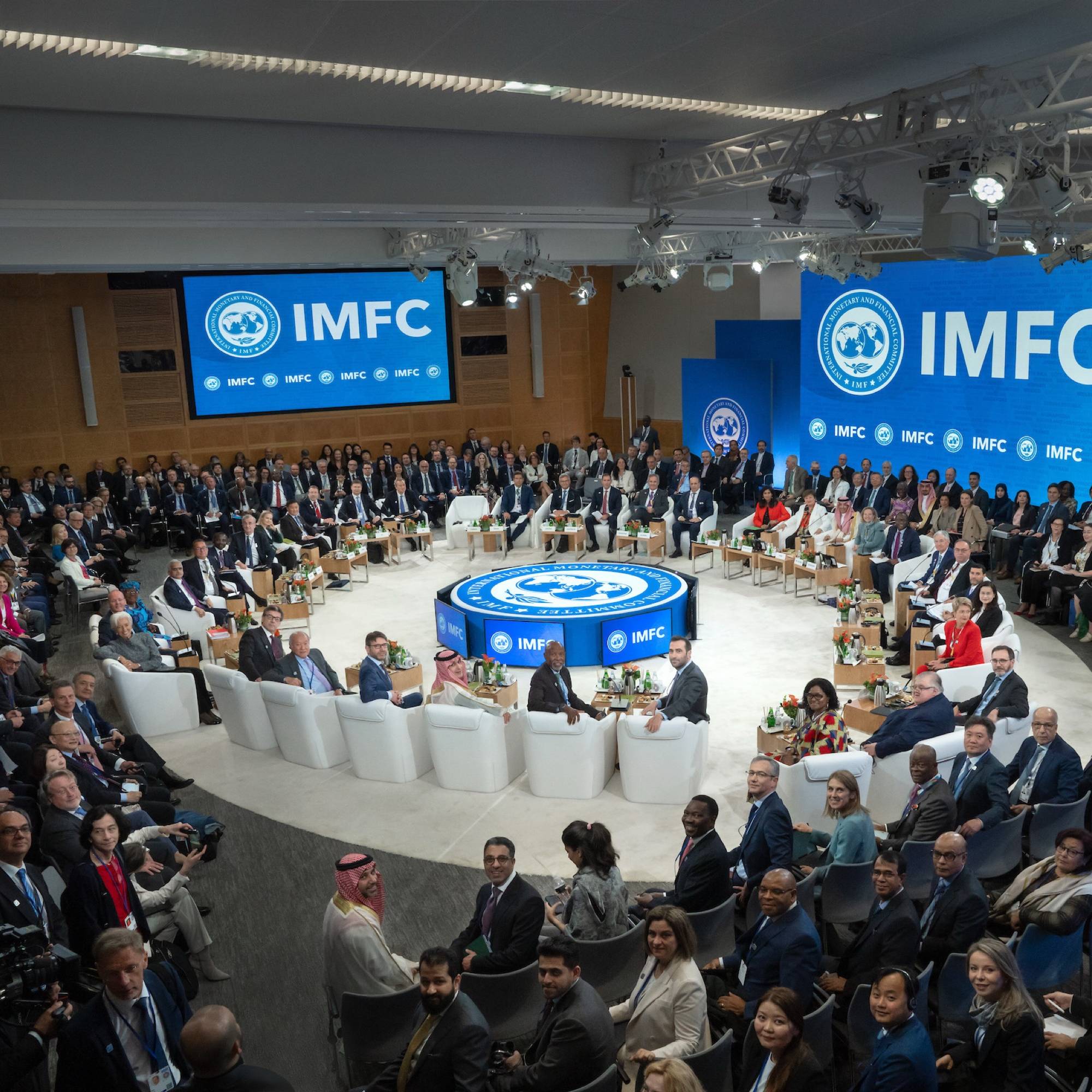 A large group of people gathered at IMFC are seated and turned around to look at the camera
