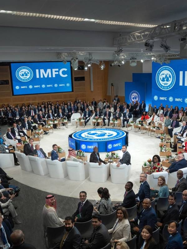 A large group of people gathered at IMFC are seated and turned around to look at the camera