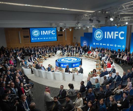 A large group of people gathered at IMFC are seated and turned around to look at the camera