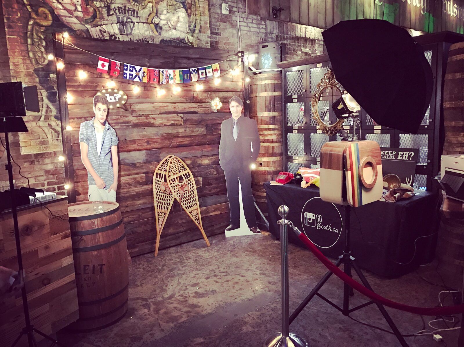 GoBooth photo booth setup with string lights and props at a rustic corporate venue