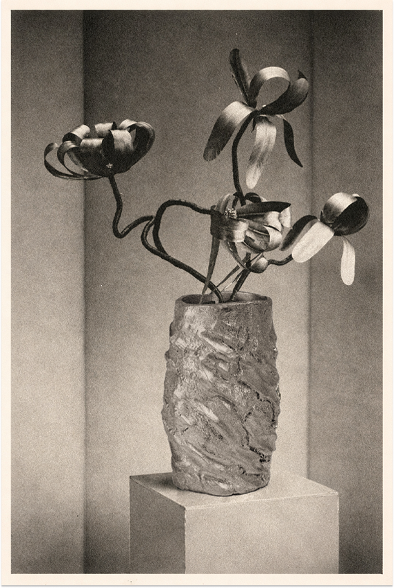 Based on the metalized feathers in orchid configurations by Madame Jean Tranchant in ca. 1929, aleni re-imagines its accompanying vessel in aluminum.  © The Regents of the University of California, The Bancroft Library, University of California, Berkeley. This work is made available under a Creative Commons Attribution 4.0 license