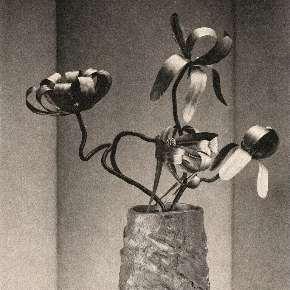 Metalized feathers in orchid configurations by Madame Jean Tranchant