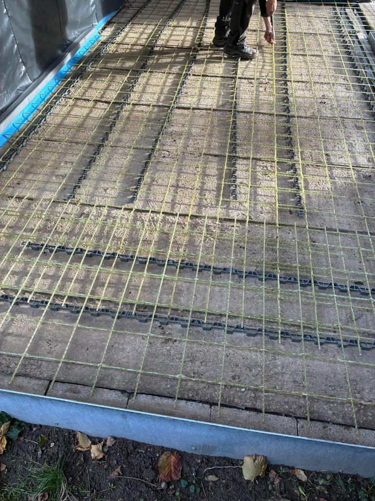 Glass-fibre terrace mesh walked on to check alignment before the pour