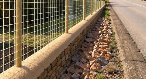 Glass-fibre mesh fencing installed along a roadside property boundary