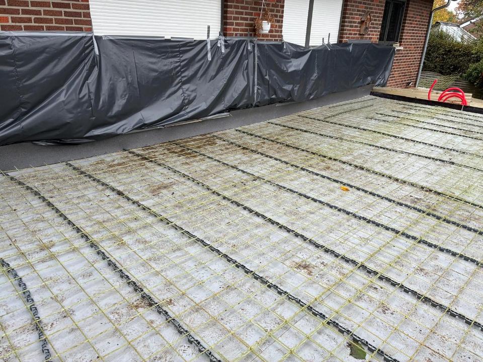 Glass-fibre mesh laid on chairs across an outdoor terrace before the concrete pour