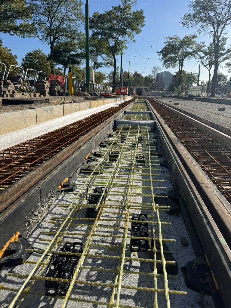 Glass-fibre mesh laid between the rails of a De Lijn tram track, with steel reinforcement in the parallel bay