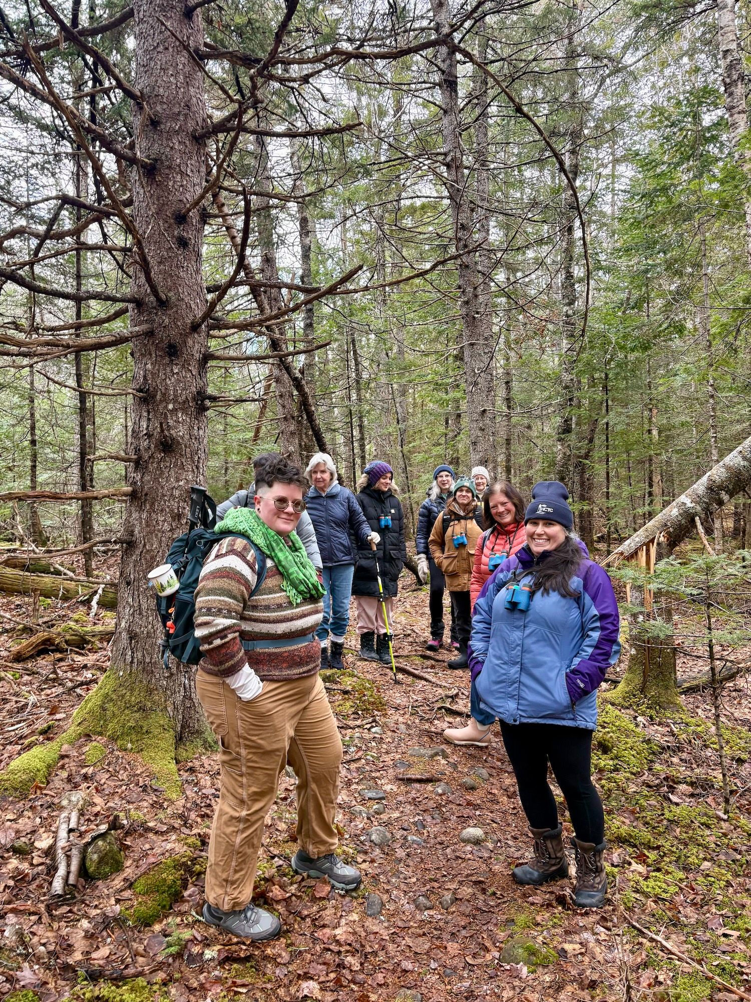 A group of outdoor hikers gathers in the wood for a Women for Healthy Rural Living program