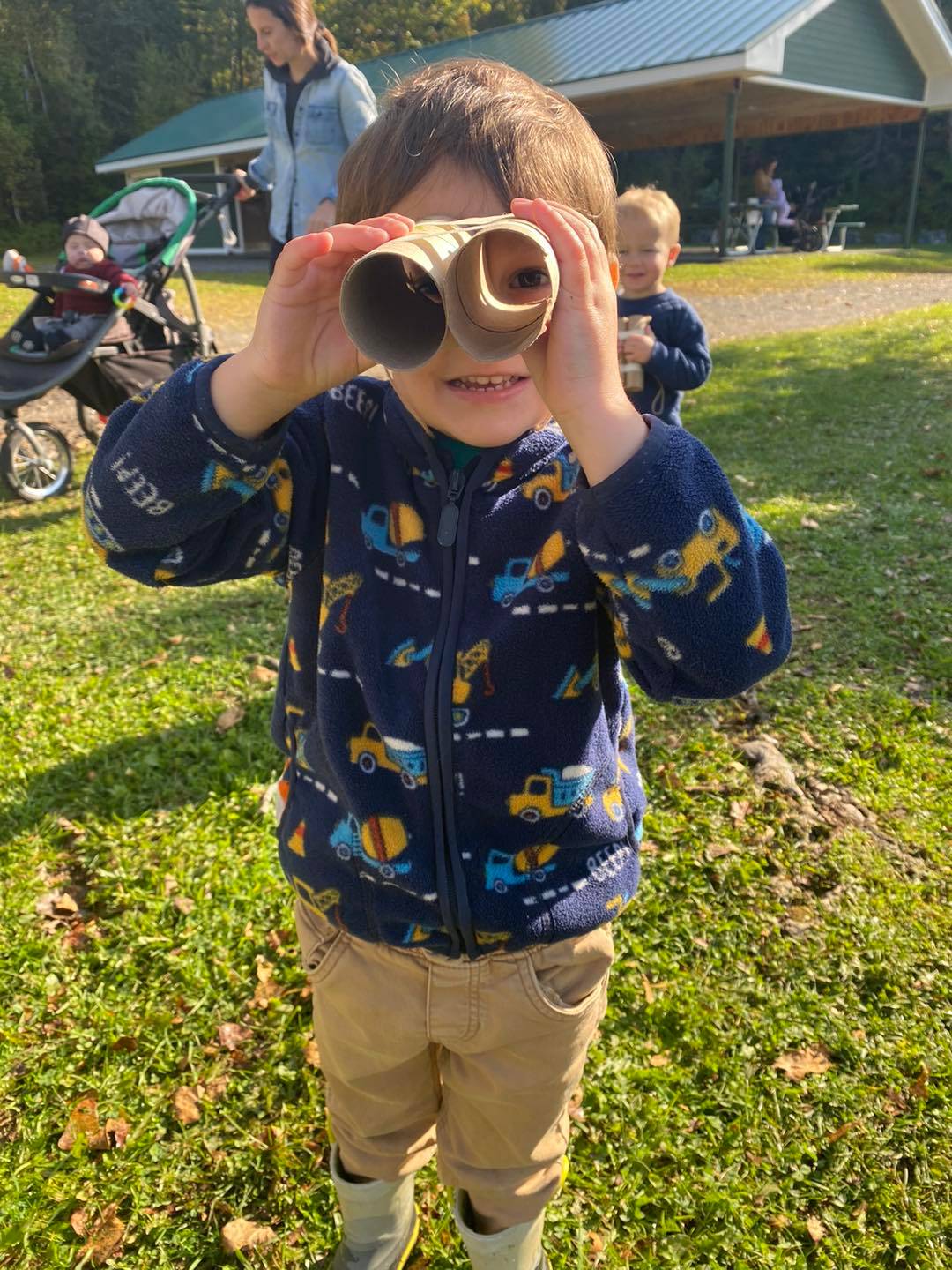 A young person looks through makeshift binoculars