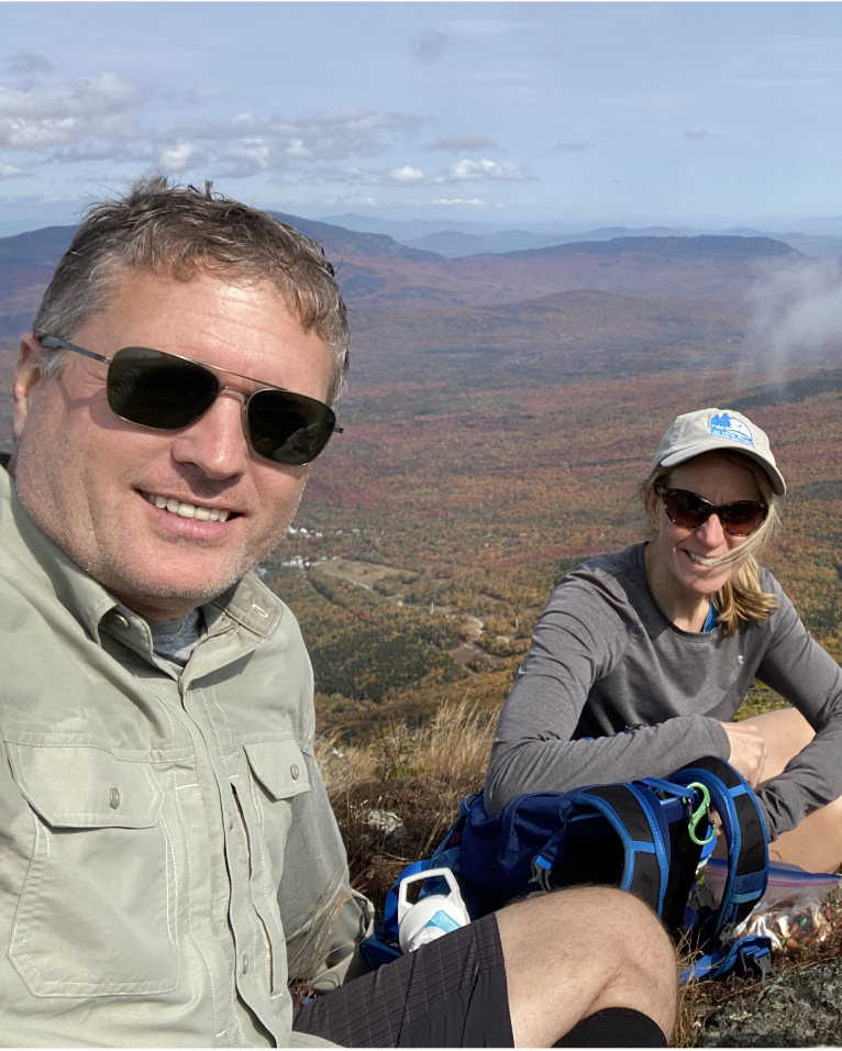 Fritz and Susan Onion wearing sunglasses on top of a mountain