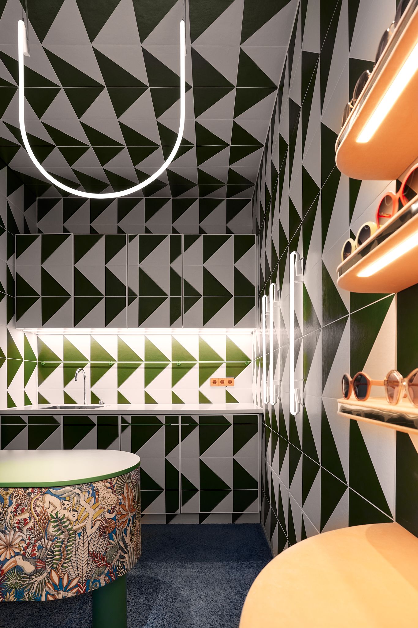 Dieses Bild zeigt den von Stephanie Thatenhorst designten Eingangsbereich des Rookies – Eyewear for Kids, der mit geometrischen Fliesen und leuchtenden Farben einen markanten ersten Eindruck schafft.