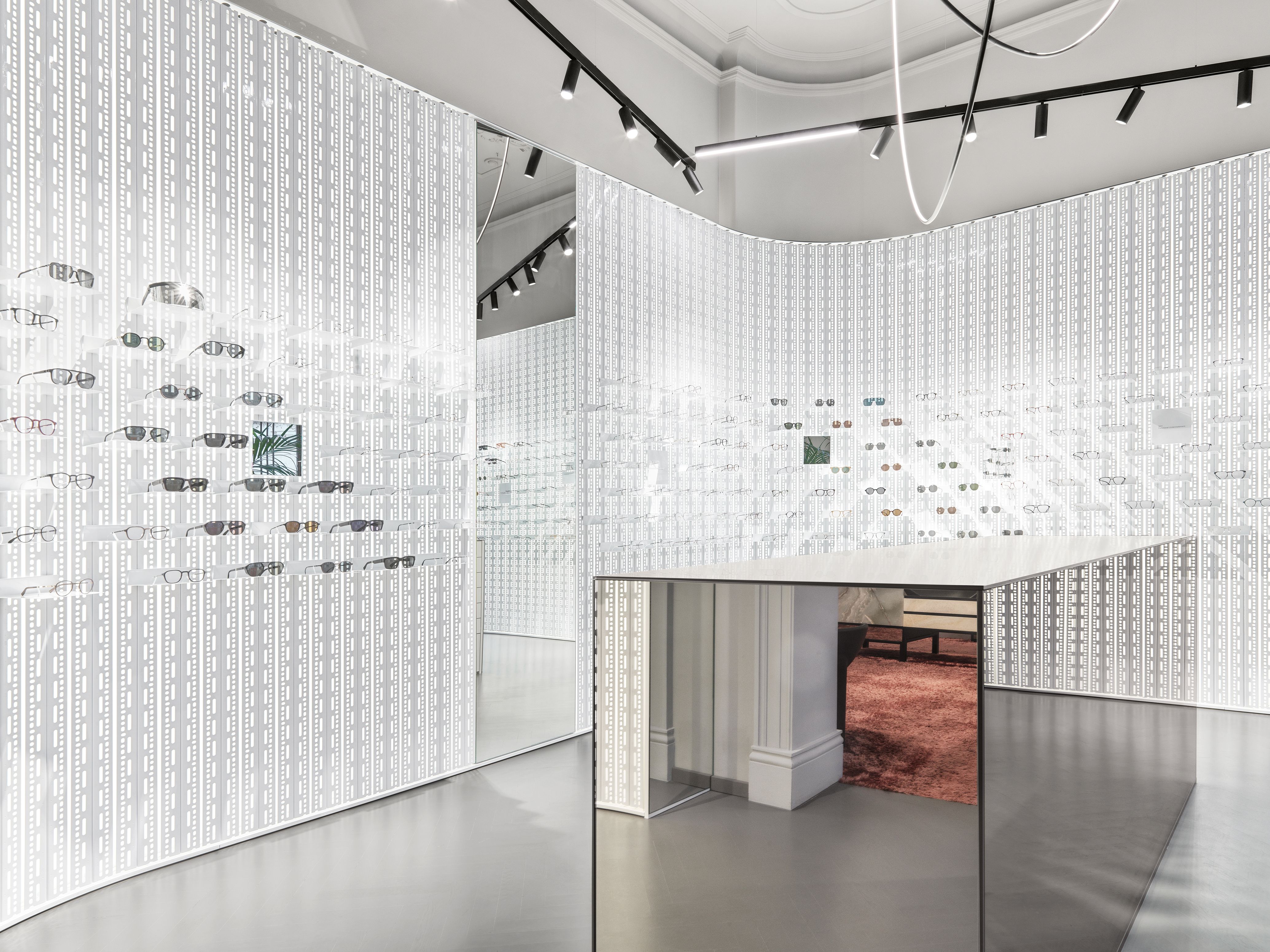 Die von Stephanie Thatenhorst designte Präsentationswand im Mykita Shop München schafft mit hinterleuchtetem Muster einen ikonischen Rahmen für exklusive Brillenmodelle.