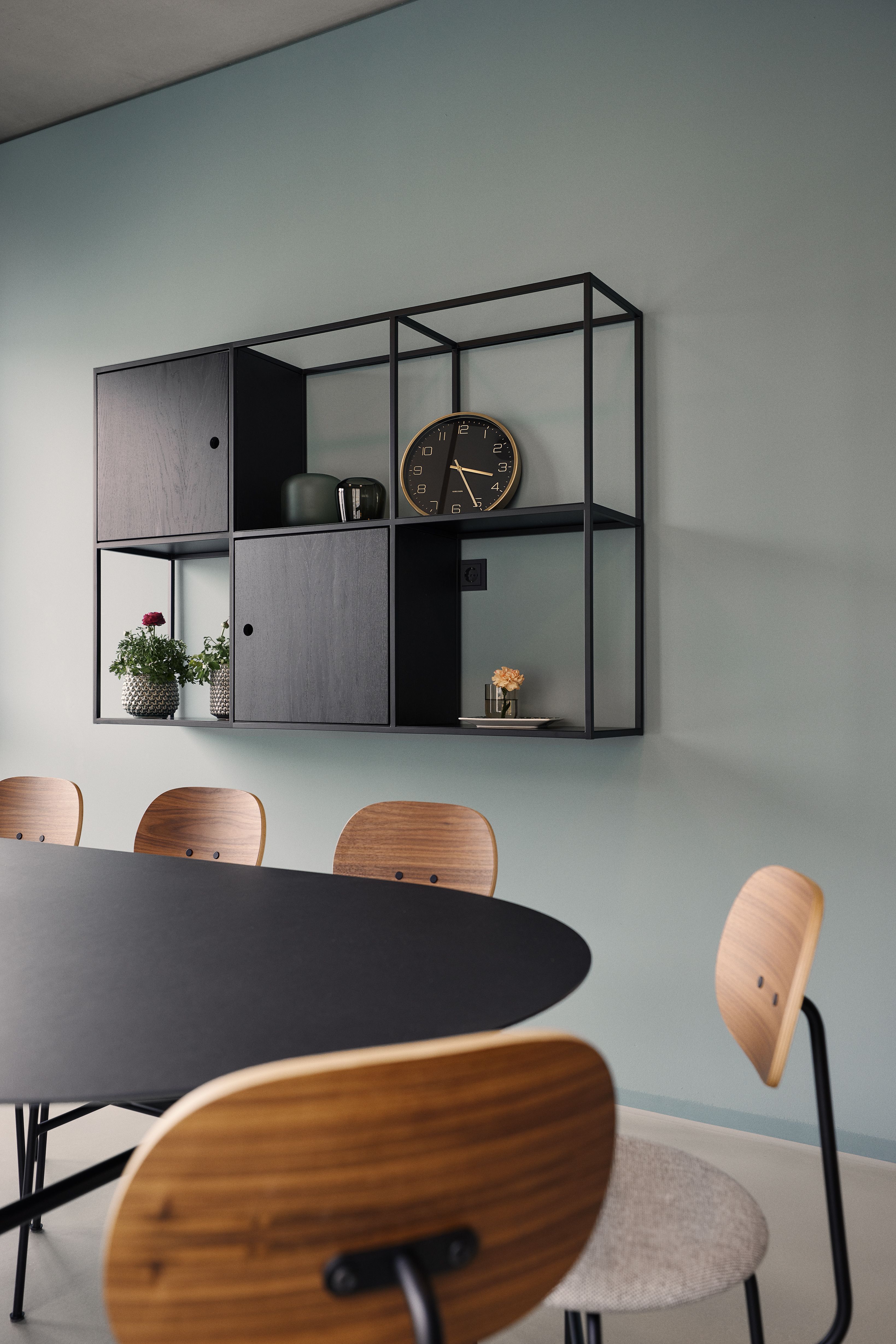 Der Besprechungsbereich mit schwarzem Tisch und Holzstühlen spiegelt die sachliche, vertrauensvolle Atmosphäre der Zahnarztpraxis Stephanie Thatenhorst wider.