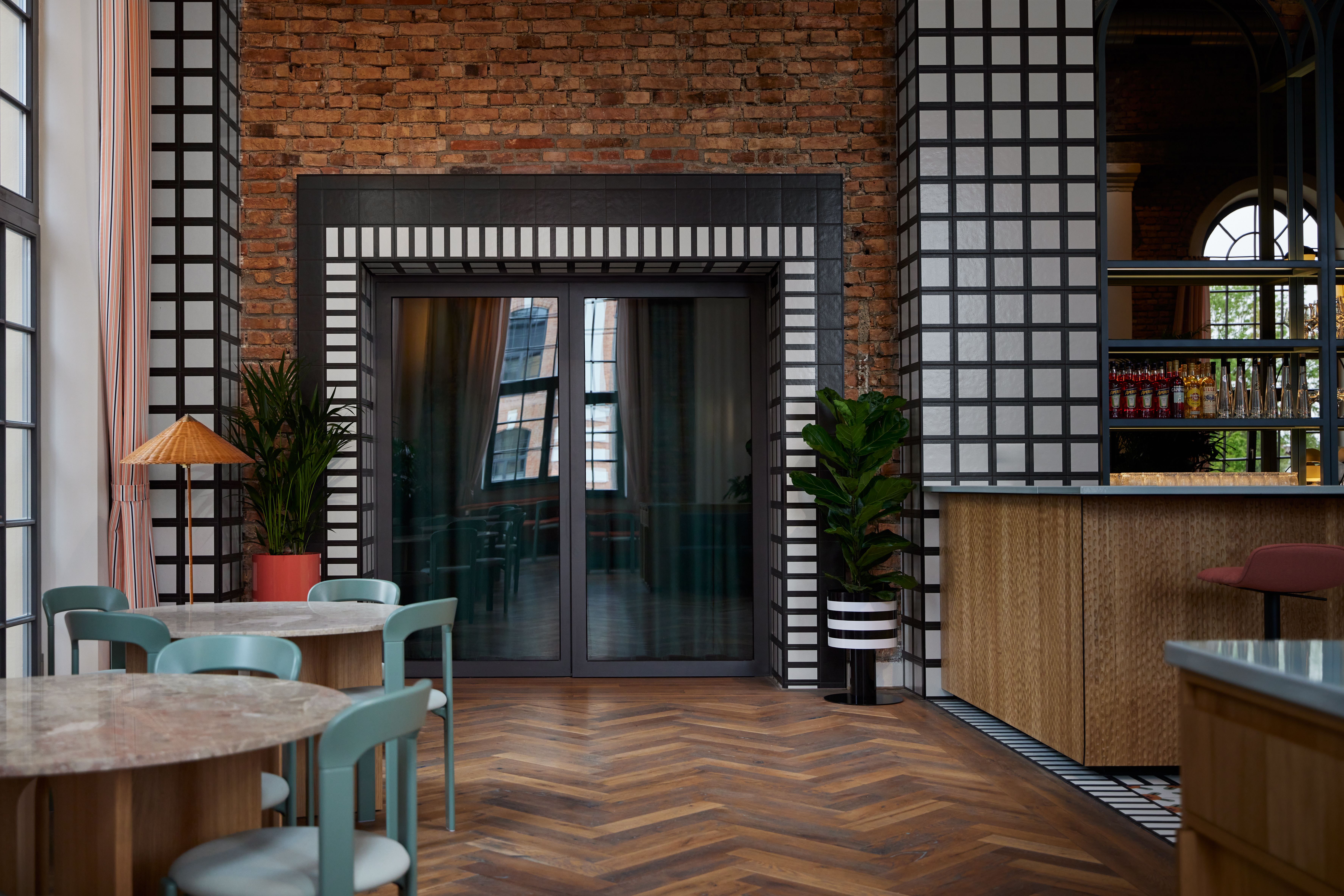 Die raumteilende Grüninszenierung im Brasserie-Hauptsaal des Turbinenhauses Kolbermoor wurde von Stephanie Thatenhorst als biophiles Zonierungskonzept in Dialog mit Industriebau-Historie geplant.