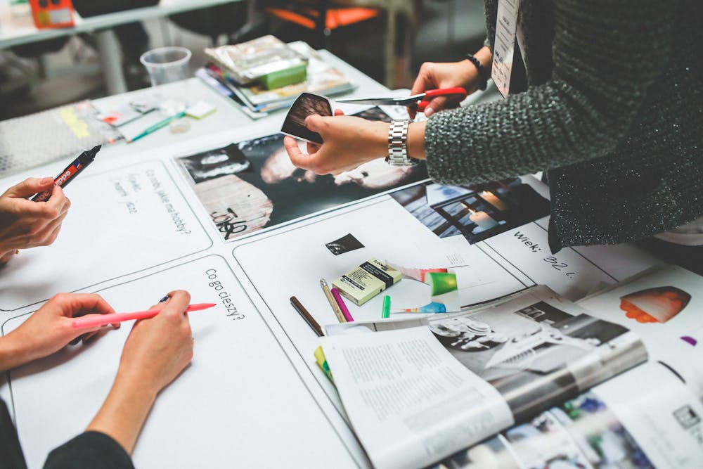 Designer creating visual brand assets at a studio workstation