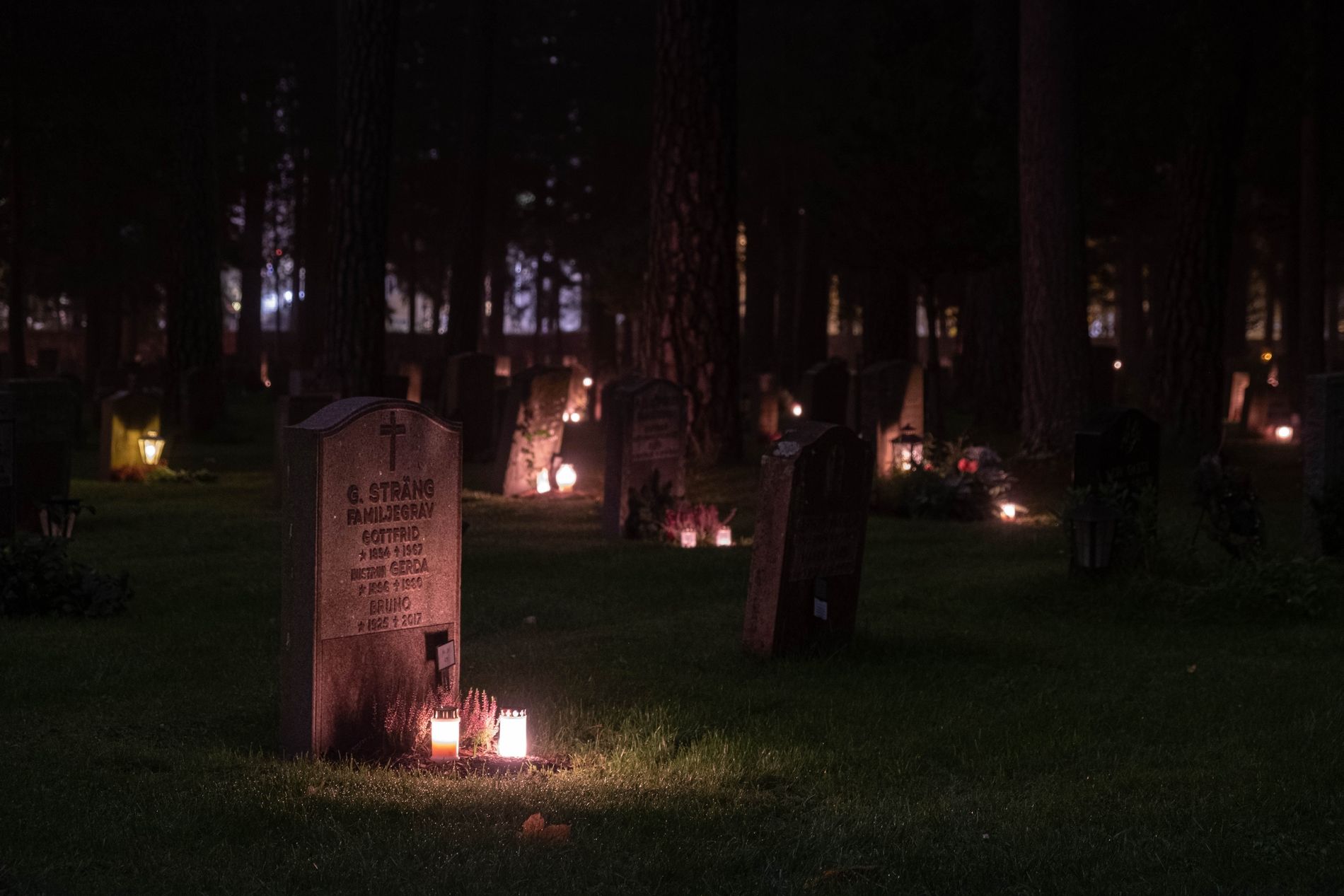 Kirkegård om natten med tente lys