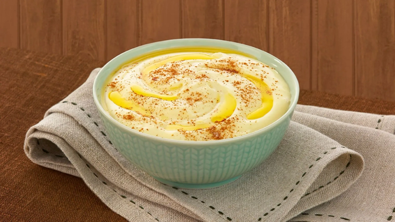 En skål med rømmegrøt, smør og kanel