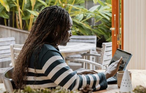 Female on her device working