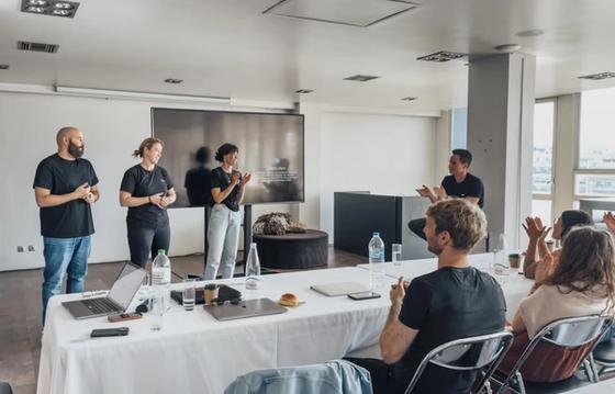 Team members engaging in a collaborative presentation and discussion in a modern conference room, emphasizing teamwork and open communication.