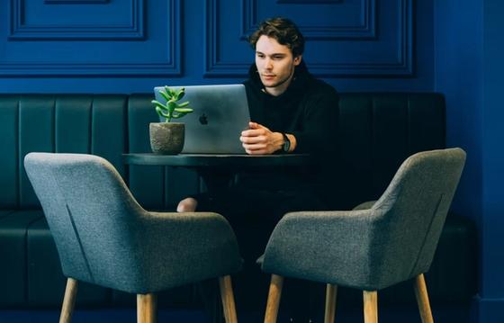A professional working remotely in a modern workspace, focusing on productivity and engagement, aligned with creating better workplace culture insights.