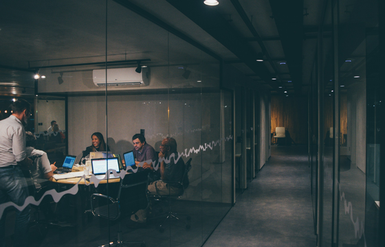 Team meeting in progress inside a modern office, discussing culture metrics and productivity