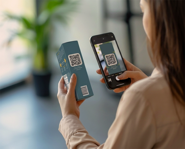 A person scanning the QR code on a Clario product box with their smartphone.