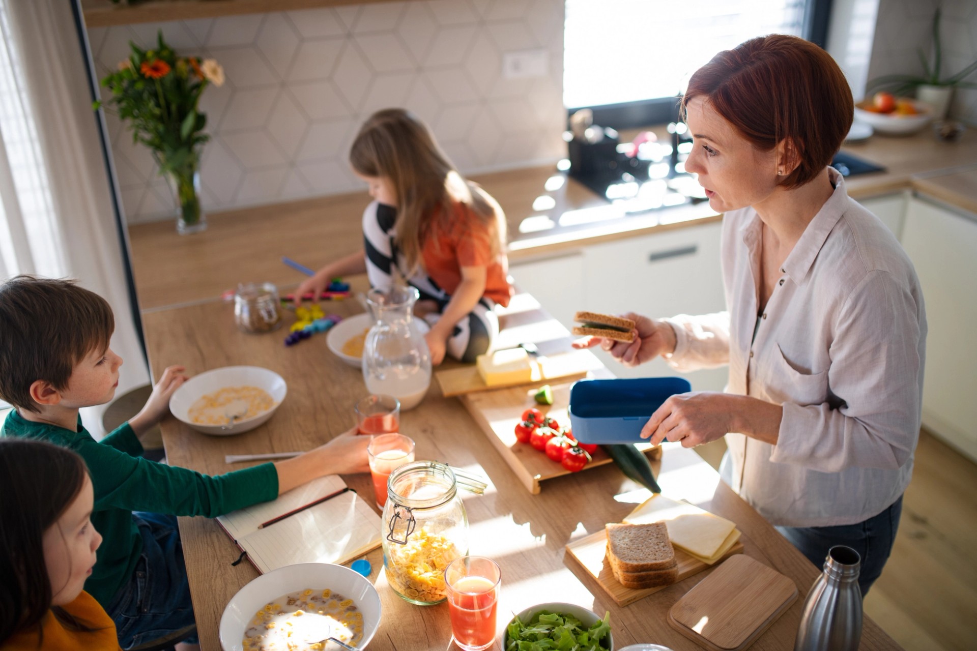 Mother super busy giving lunch for her kids