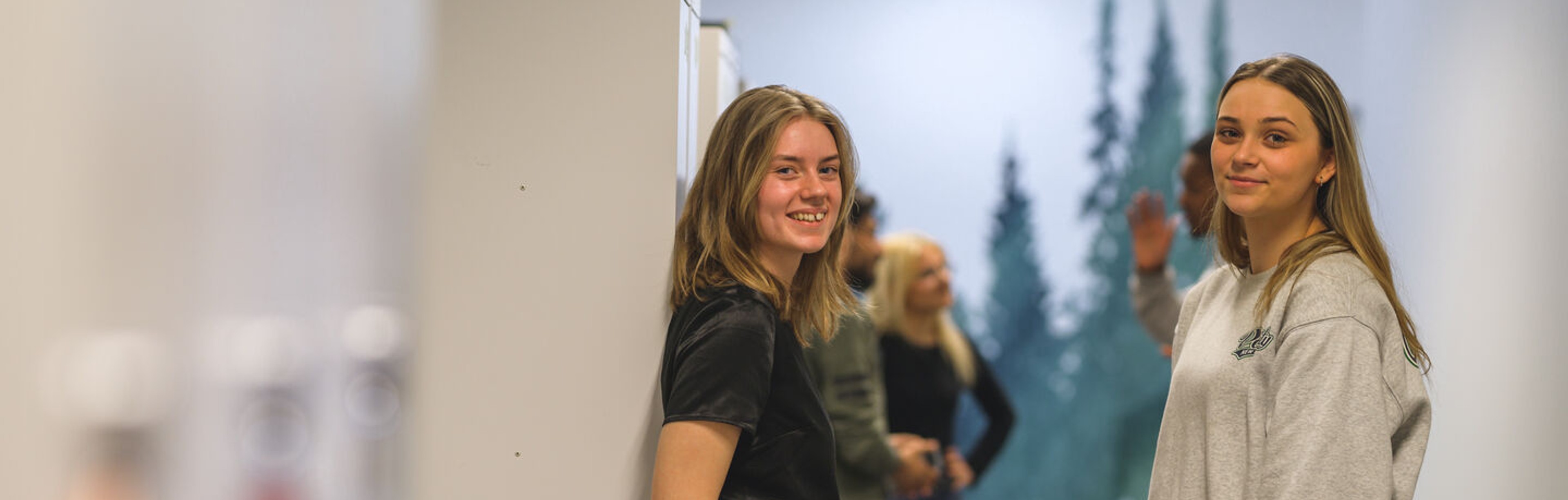 Två elever ler mot kameran